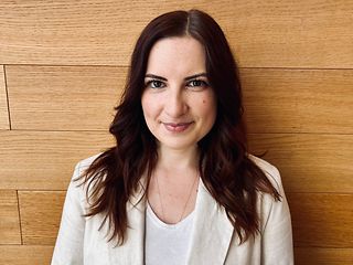 A woman smiles at the camera