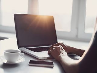 Laptop, mobile phone and coffee cup on the table